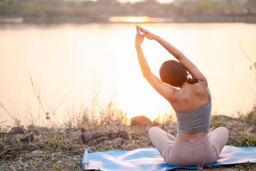 Mindful breathing stretch beside a calm lake